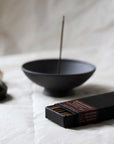 artisan incense holder in purple anthracite clay with natural incense sticks